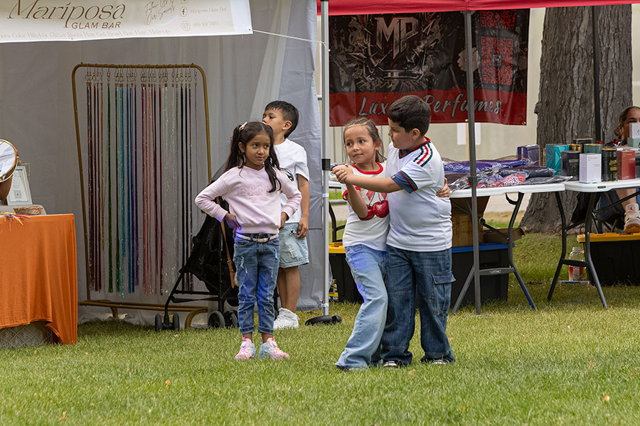 A boy and a girl dancing during the Mexican Independence Day Celebration event at the Snake River Greenbelt, with another girl jealosuly standing nearby. | Daniel V. Ramirez, EastIdahoNews.com