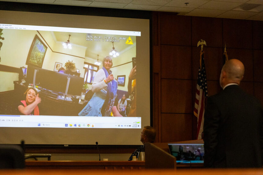 An Ada County prosecuting attorney and an Idaho State Police trooper watch body cam footage leading up to the arrest of the Rev. Sara LaWall on trespassing charges at her trial in Boise on Sept. 1, 2026. | Kyle Pfannenstiel, Idaho Capital Sun