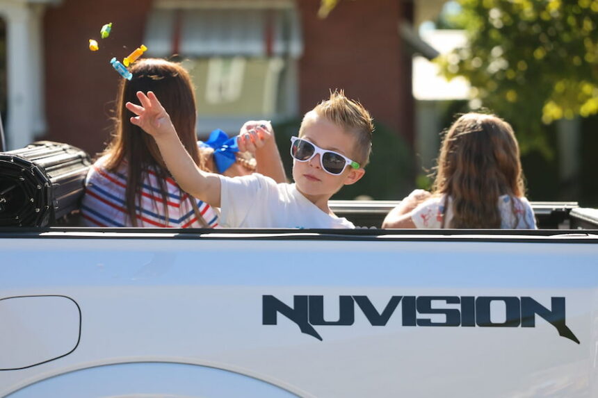 boy throws candy to crowd