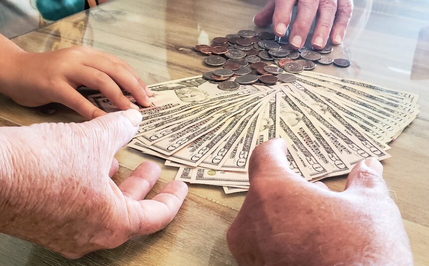 child and senior hands over money and coins 2026 03 24 04 58 38 utc