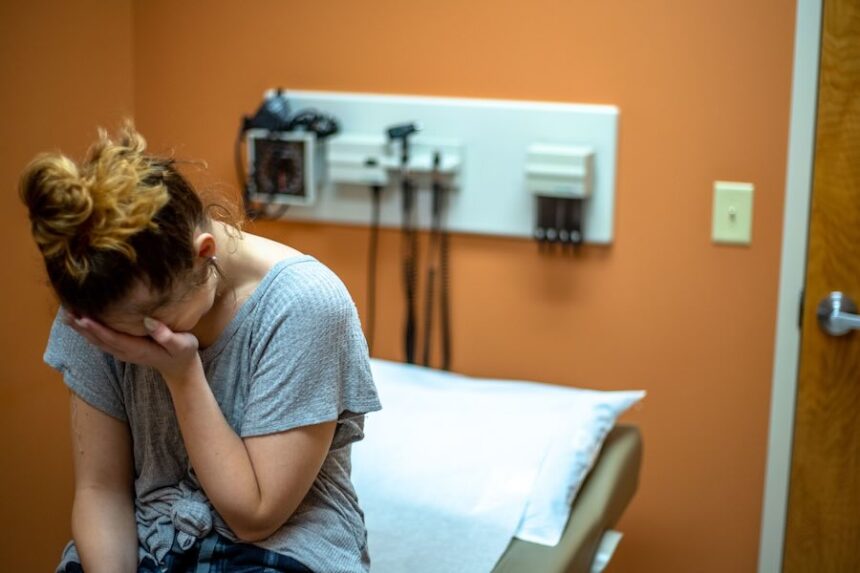 One-third of women in the United States have struggled to get doctors to take their symptoms seriously, according to a new survey. This file image shows a woman who is upset or crying in a doctor's office.