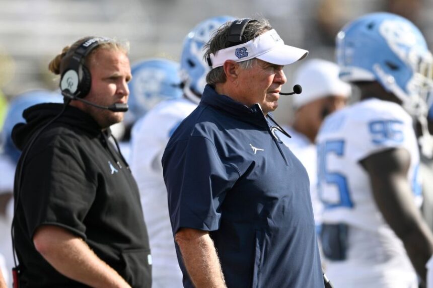 FILE - North Carolina head coach Bill Belichick, center, and defensive coordinator Steve Belichick, left, look on during the first half of an NCAA football game against Central Florida, Saturday, Sept. 20, 2025, in Orlando, Fla. (AP Photo/Phelan M. Ebenhack, File)