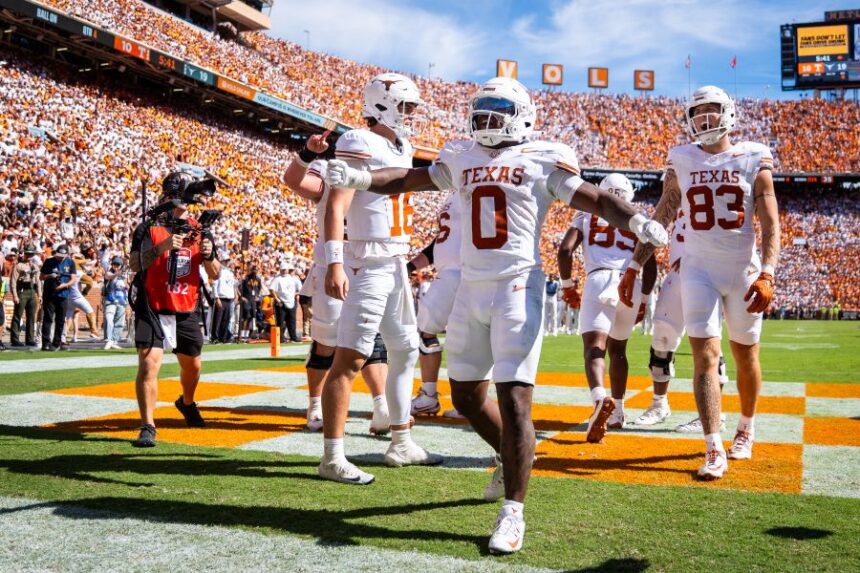 Teammates celebrate with Texas running back Raleek Brown (0) after scoring a touchdown during the second half of an NCAA college football game against Tennessee in Knoxville, Tenn., Saturday, Sept. 26, 2026. (Sara Diggins/The San Antonio Express-News via AP)