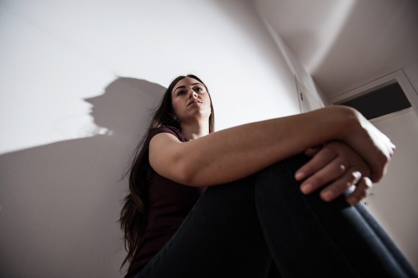 contemplative woman sitting near wall looking upwa 2026 03 26 04 45 16 utc