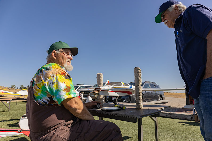 (Left) Member of the Desert Eagles RC Club George Neander and (right) the club's president Stu Eddins talking how to repair a rc plane that suffered damage earlier in the day. | Daniel V. Ramirez, EastIdahoNews.com