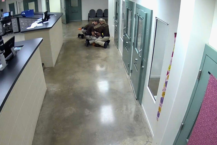 deputies kneel on Durrah's back
