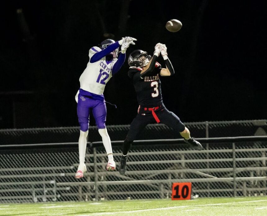 Hillcrest's Ethan Saunders and Century's Justus Mangum leap for the ball during Friday's game. | Courtesy Amy Ward via EastIdahoSports.com.