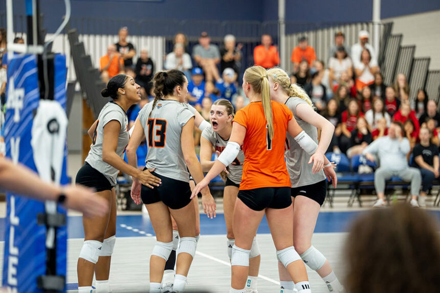 Idaho state volleyball including Rexburg alums Aspen Boice (1), Nora Waddoups (yelling) and Mia Walsh (far rght)