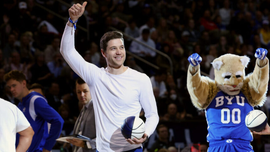 Former BYU star Jimmer Fredette gives a thumbs up to fans during a timeout as BYU and Utah play at the Marriott Center in Provo on Saturday, Dec. 17, 2022. BYU won 75-66.