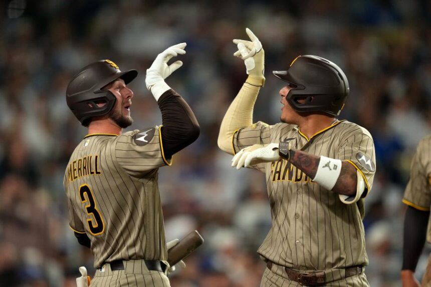 San Diego Padres' Manny Machado, right, is congratulated by Jackson Merrill after hitting a two-run home run during the fourth inning of a baseball game against the Los Angeles Dodgers, Wednesday, Sept. 23, 2026, in Los Angeles. (AP Photo/Mark J. Terrill)