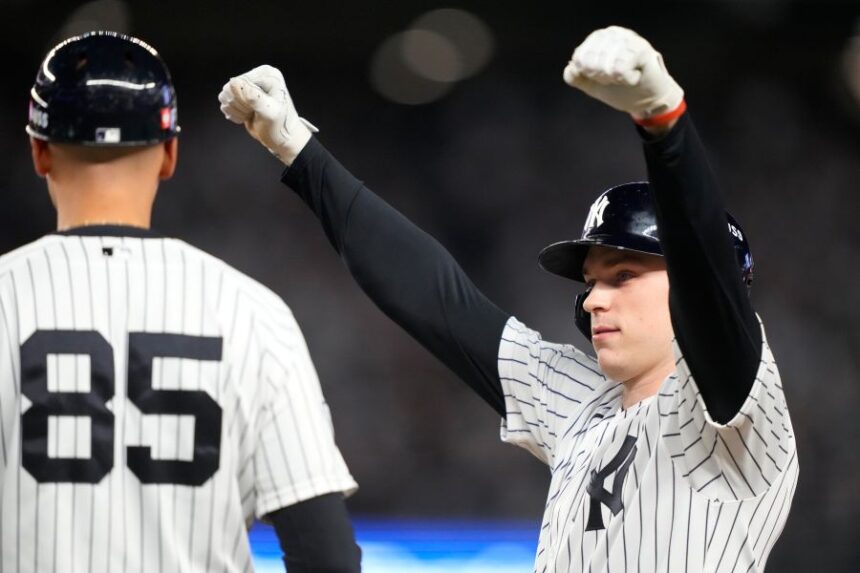 New York Yankees' Ben Rice, right, reacts next to first base coach Dan Fiorito, after collecting an RBI on a bases loaded single against the Boston Red Sox during the seventh inning in Game 1 of baseball's American League Wild Card Series, Tuesday, Sept. 29, 2026, in New York. (AP Photo/Yuki Iwamura)