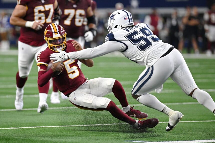 Dallas Cowboys linebacker Tyrus Wheat (59) tackles Washington Commanders quarterback Jayden Daniels (5) in the first half during an NFL football game in Arlington, Texas, Sunday, Sept. 20, 2026. (AP Photo/Jessica Tobias)