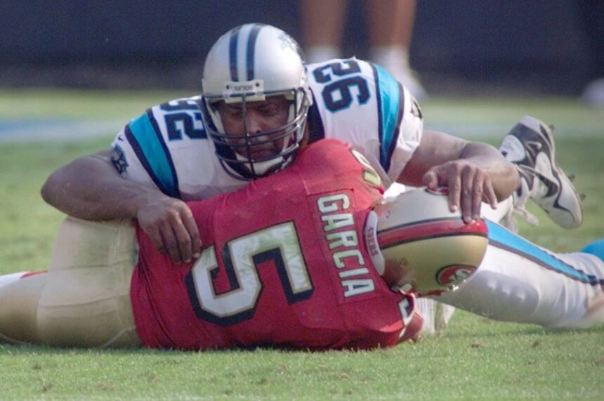 FILE - Carolina Panthers' Reggie White (92) sacks San Francisco 49ers quarterback Jeff Garcia (5) in the fourth quarter of the Panthers' win in Charlotte, N.C., Oct. 22, 2000. (AP Photo/Chuck Burton, File)