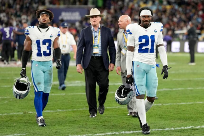 Dallas Cowboys safety Caleb Downs (13) and cornerback Caelen Carson (21) leave the field after an NFL football game against the Baltimore Ravens in Rio de Janeiro, Sunday, Sept. 27, 2026. (AP Photo/Andre Penner)
