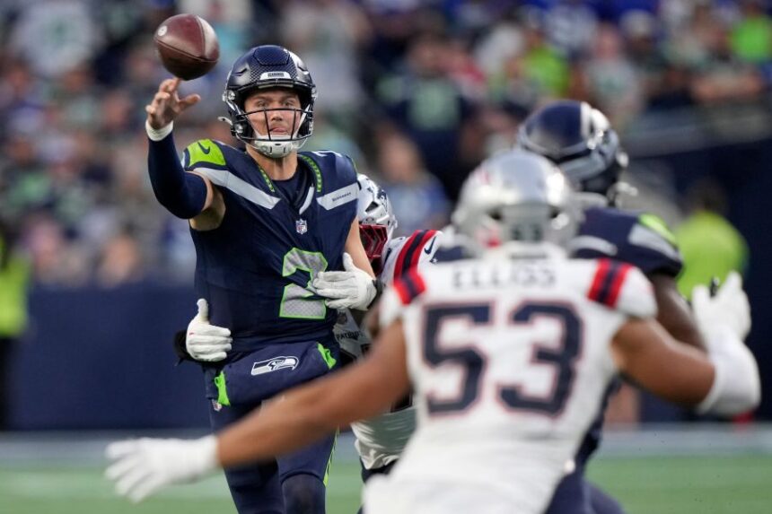 Seattle Seahawks quarterback Drew Lock (2) throws under pressure during the second half of an NFL football game against the New England Patriots, Wednesday, Sept. 9, 2026, in Seattle. (AP Photo/Stephen Brashear)
