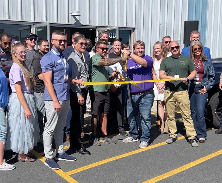 Idaho Falls YMCA CEO Tanner Rohne, third from right holding the scissors, just before cutting the ribbon on the soccer complex. | Rett Nelson, EastIdahoNews.com