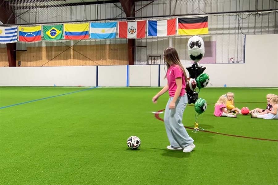 Woman kicking a soccer ball on the new turf Wednesday morning. | Rett Nelson, EastIdahoNews.com
