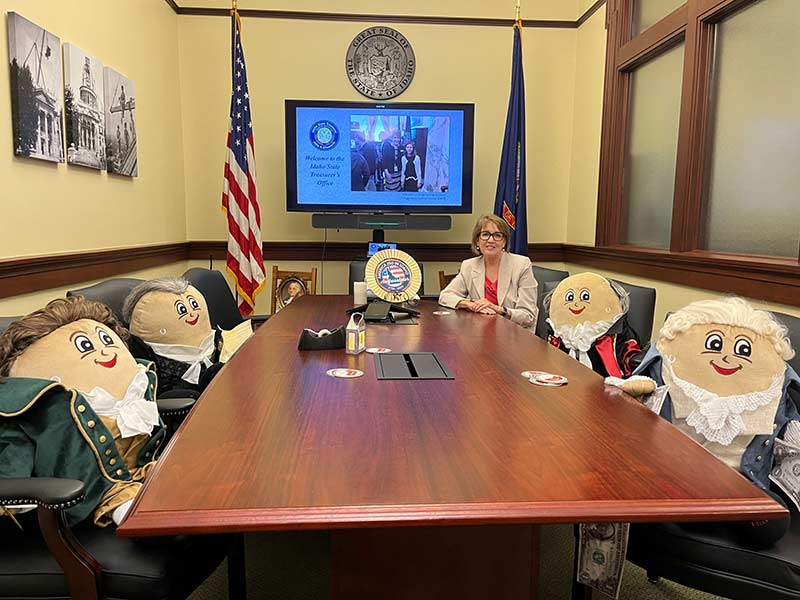 Idaho State Treasurer Julie Ellsworth poses for a photo at the Idaho State Capitol with four Revolutionary Spuddy Buddy dolls that she dressed in custom costumes made by hand for the America250 celebrations. (File photo by Clark Corbin/Idaho Capital Sun)