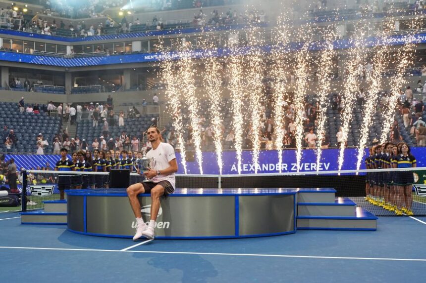 Alexander Zverev, of Germany, holds his trophy after winning the men's singles final of the U.S. Open tennis championships against Ben Shelton, of the United States, Sunday, Sept. 13, 2026, in New York. (AP Photo/Frank Franklin II)
