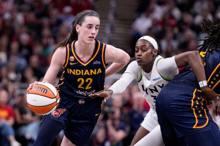 Indiana Fever guard Caitlin Clark (22) drives past Minnesota Lynx guard Maya Caldwell (3) in the second half of a WNBA basketball game in Indianapolis, Tuesday, Sept. 22, 2026. (AP Photo/Michael Conroy)