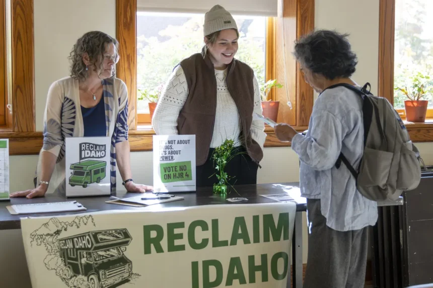 Becky Gillette, left, and Abi Sanford, both of Reclaim Idaho, chat Wednesday with an audience member about Idaho House Joint Resolution 4 after a talk by Reclaim Idaho Executive Director Luke Mayville at the 1912 Center in Moscow, Idaho. | Courtesy Geoff Crimmins / The Spokesman-Review