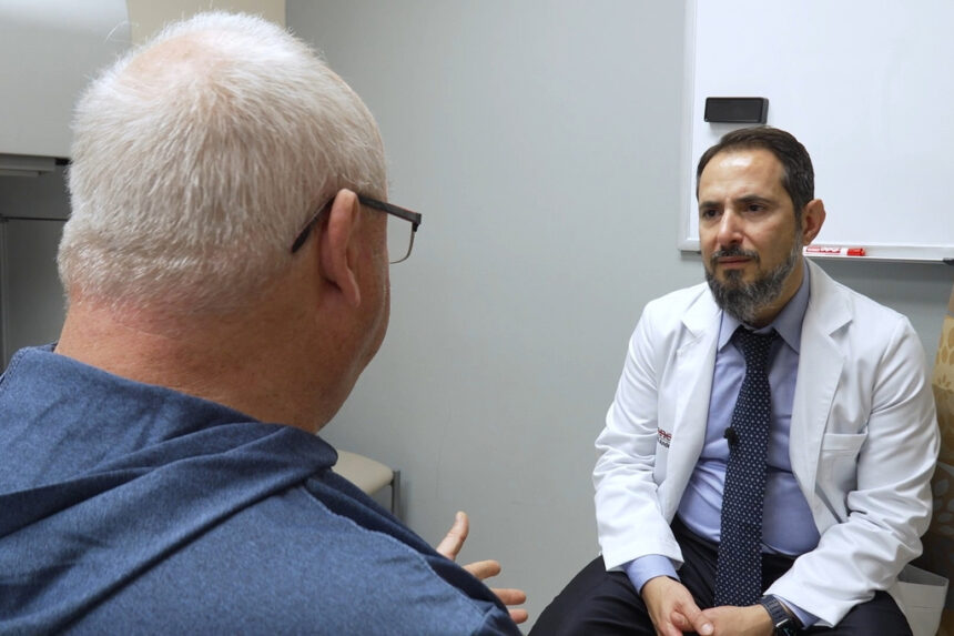 In this image made from video, Tony Hout, left, talks with Dr. Hussein Tawbi at UT MD Anderson Cancer Center in Houston, Monday, Oct. 19, 2026. | Courtesy AP