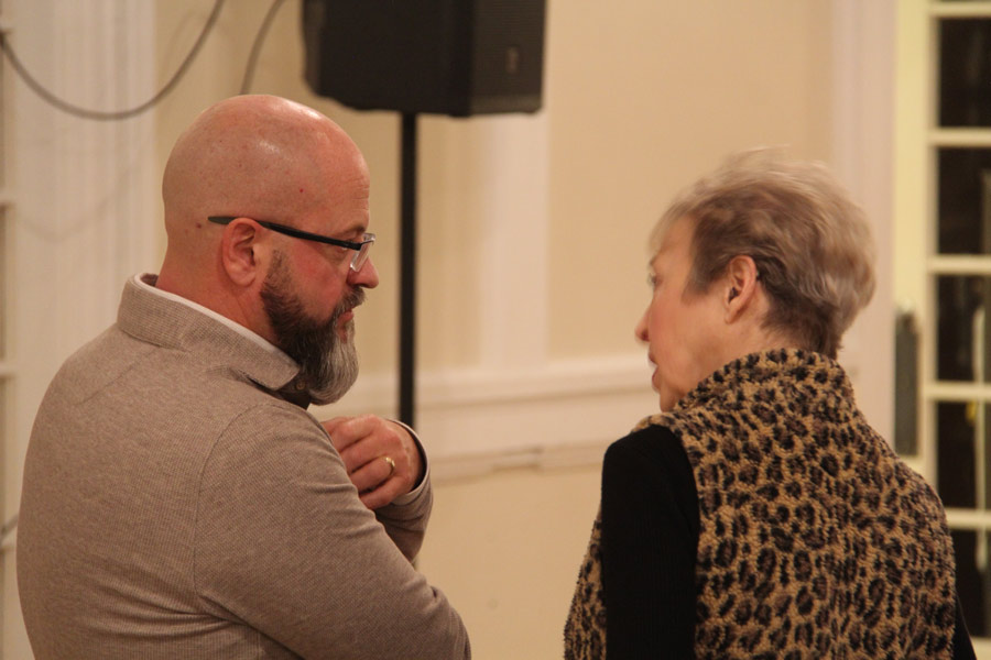 Ruchti speaks with an attendee after the meeting.