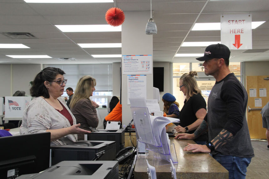 Elections staff check in early voters at the Bannock County Elections Office.