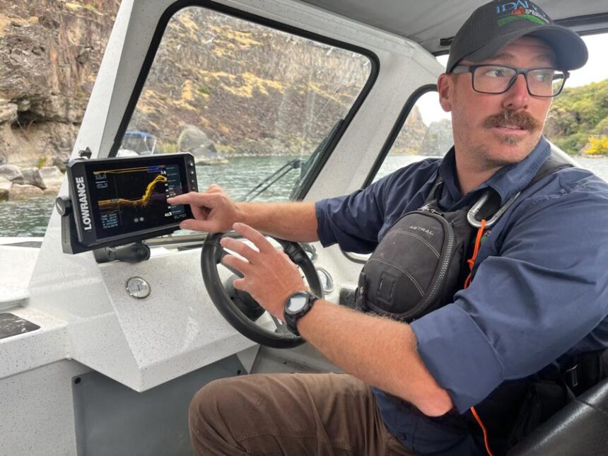 Jeremey Varley, the Idaho State Department of Agriculture’s southern chief treatment engineer, explains the state’s strategy for eradicating invasive quagga mussels during a boat tour of the infested portion of the Snake River on Oct. 3, 2025. | Clark Corbin, Idaho Capital Sun