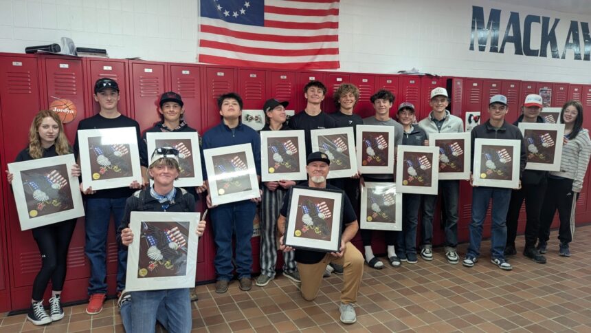 Mackay High history teacher Jess Johnson's students hold their Earl Henry Sr. prints.