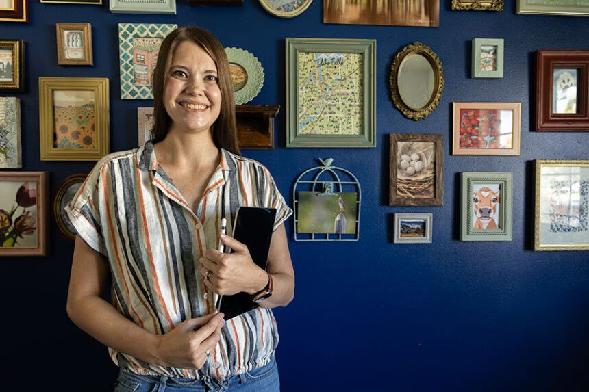 Krystal Leonardson, owner of Krystal Leonardson Art, posing in her home studio, where she creates artwork of local businesses and pets. | Daniel V. Ramirez, EastIdahoNews.com