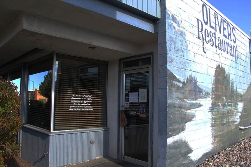 A sign on the front entrance to Olivers Restaurant informs passersby of the temporary closure.