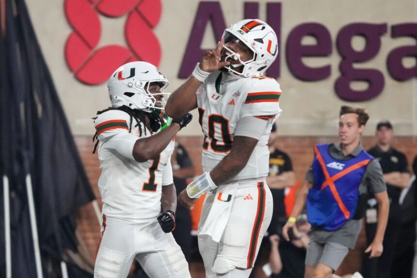 Miami quarterback Darian Mensah (10) and wide receiver Malachi Toney (1) celebrate after Toney's touchdown against Wake Forest during the second half of an NCAA college football game in Winston-Salem, N.C., Friday, Sept. 18, 2026. (AP Photo/Chuck Burton)