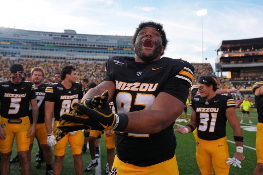 Missouri defensive tackle Jason Dowell celebrates a victory over Florida with his teammates following an NCAA college football game Saturday, Oct. 3, 2026, in Columbia, Mo. (AP Photo/Jeff Roberson)