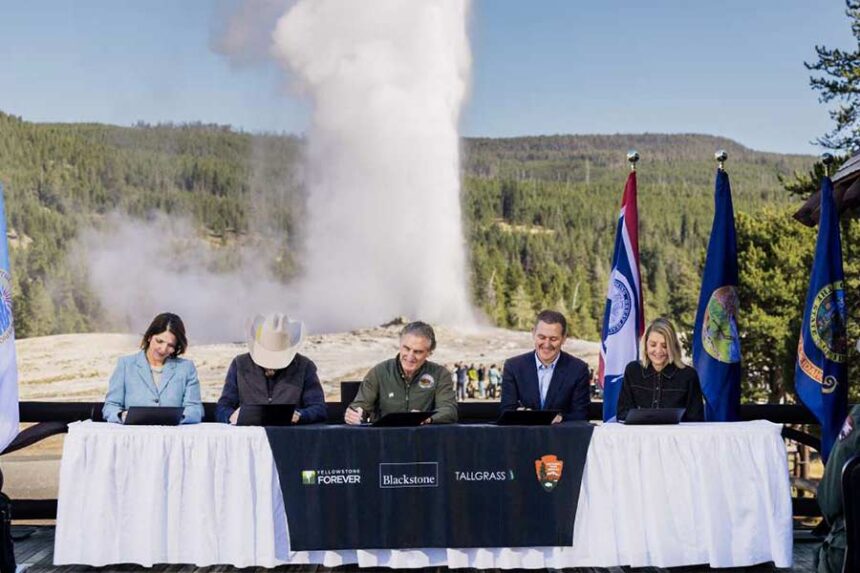 Secretary of the Interior Doug Burgum, center, signs an agreement establishing the Tallgrass WYld Yellowstone Initiative at the Old Faithful Inn at Yellowstone National Park on Friday. The fund creates $105 million for projects at the nation's oldest national park. | (Blackstone via National Park Service)