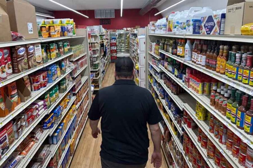 General Manager Brian Horak walks down an aisle at Post 60 Market in Emerson, Nebraska. A new national report shows how everyday costs have increased for Americans. (Photo by Kevin Hardy/Stateline)