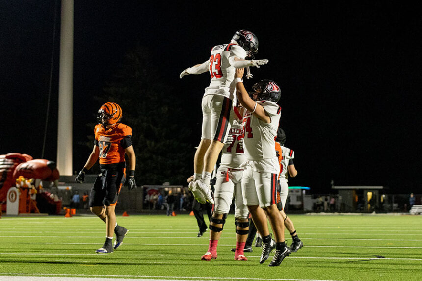 Hillcrest's Austin Snarr (54) hoists Jake Stephens (33)