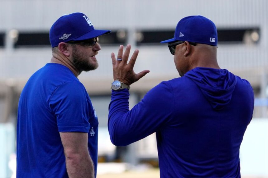 Los Angeles Dodgers third baseman Max Muncy, left, talks with manager Dave Roberts during practice ahead of a baseball NL Division Series Thursday, Oct. 1, 2026, in Los Angeles. (AP Photo/Mark J. Terrill)