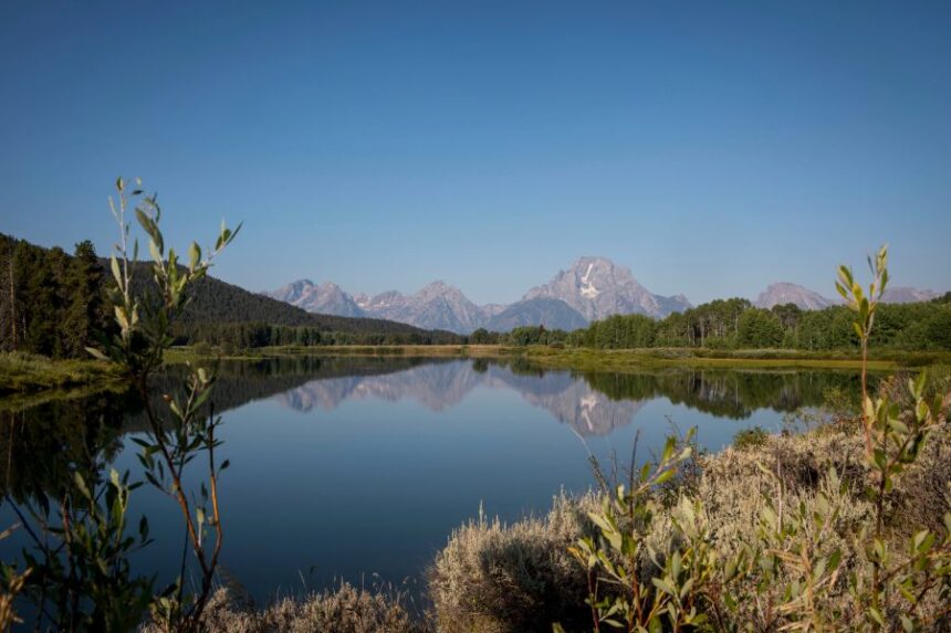 FILE – The Teton mountains reflect on Oxbow Bend in Grand Teton National Park in Moran, Wyo., Aug. 22, 2025. | Amber Baesler, Associated Press, File.