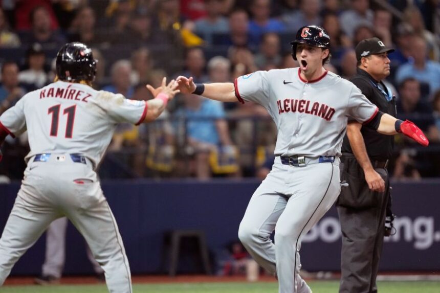 Cleveland Guardians' José Ramírez and Chase DeLauter celebrate after scoring on a single by Nathaniel Lowe against the Tampa Bay Rays during the eighth inning in Game 1 of an American League Championship Series baseball game in St. Petersburg, Fla. Monday, Oct. 12, 2026. (AP Photo/David J. Phillip)