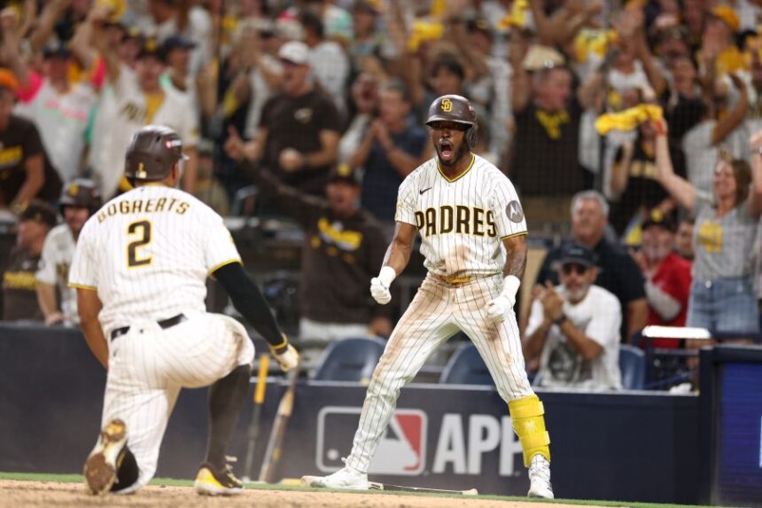 San Diego Padres' Samad Taylor, right, celebrates as teammate Xander Bogaerts (2) scores during the sixth inning in Game 3 of baseball's National League Division Series against the Milwaukee Brewers Tuesday, Oct. 6, 2026, in San Diego. (AP Photo/Derrick Tuskan)