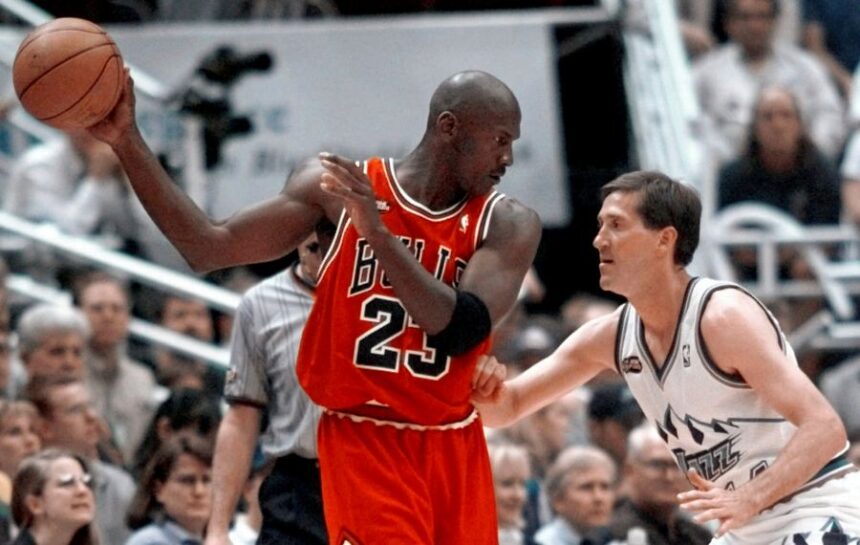 FILE - Chicago Bulls' Michael Jordan pulls the ball out of reach of Utah Jazz guard Jeff Hornacek during third quarter action in Game 2 of the NBA Finals in Salt Lake City, June 5, 1998. (AP Photo/Mark J. Terrill, file)