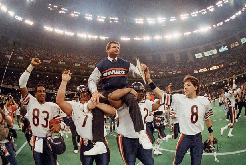 FILE - In this Jan. 26, 1986, file photo, Chicago Bears coach Mike Ditka is carried off the field by Steve McMichael, left, and William Perry after the Bears defeated the New England Patriots 46-10 in NFL football's Super Bowl XX in New Orleans. Willie Gault (83) and Maury Buford (8) join the celebration. (AP Photo/Phil Sandlin, File)