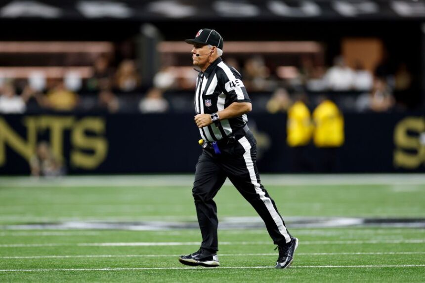 FILE - Line judge Jeff Seeman (45) works during an NFL preseason football game between the New Orleans Saints and the Jacksonville Jaguars in New Orleans, Aug. 15, 2026. (AP Photo/Tyler Kaufman, File)
