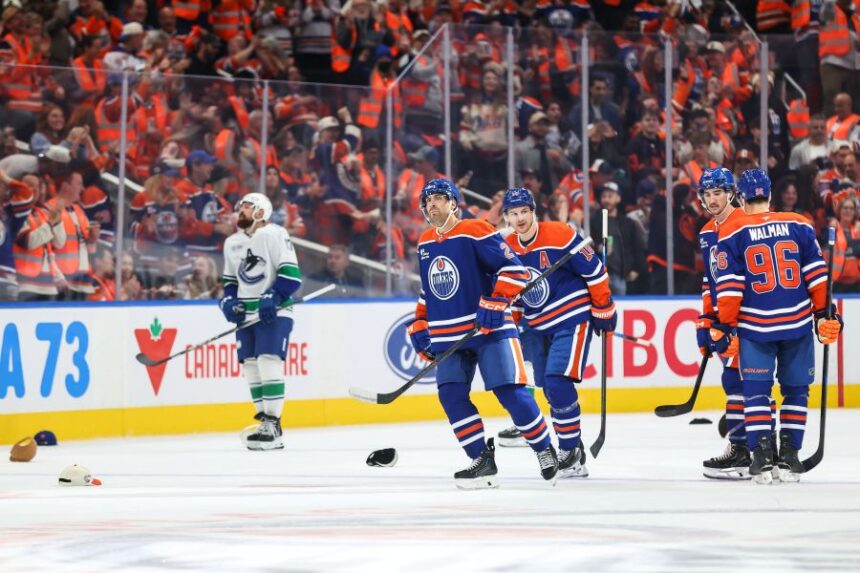 Edmonton Oilers' Evan Bouchard (2) celebrates his hat trick goal against the Vancouver Canucks during third period NHL hockey action in Edmonton on Tuesday, Sept. 29, 2026. (Codie McLachlan/The Canadian Press via AP)