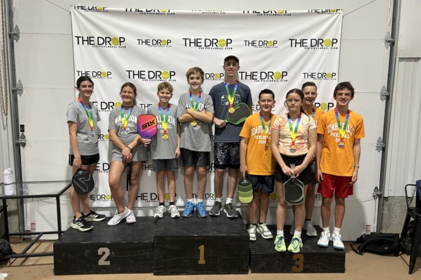 Pickleball players pose with tournament medals. | Courtesy Kristy Wilson.