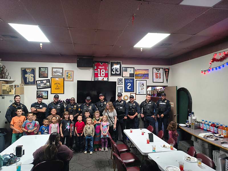 Idaho Falls police pose for a photo with Jackson at Papa Tom's Pizza. | Courtesy Brittany Carl