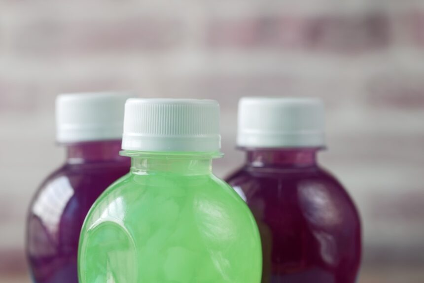 plastic bottles of sports drink on table, gatorade, powerade