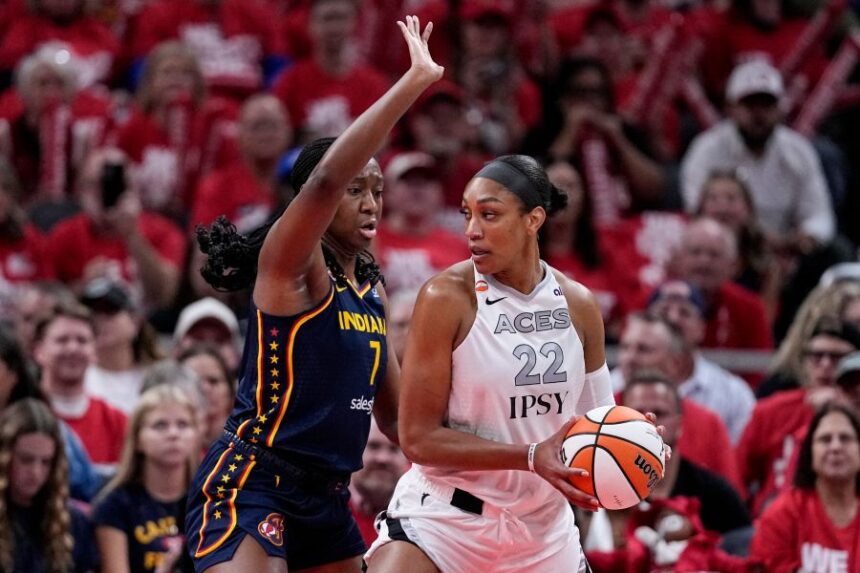 Indiana Fever center Aliyah Boston (7) defends Las Vegas Aces center A'ja Wilson (22) during the first half in Game 2 of a WNBA basketball first-round playoff series in Indianapolis, Tuesday, Sept. 29, 2026. (AP Photo/Michael Conroy)