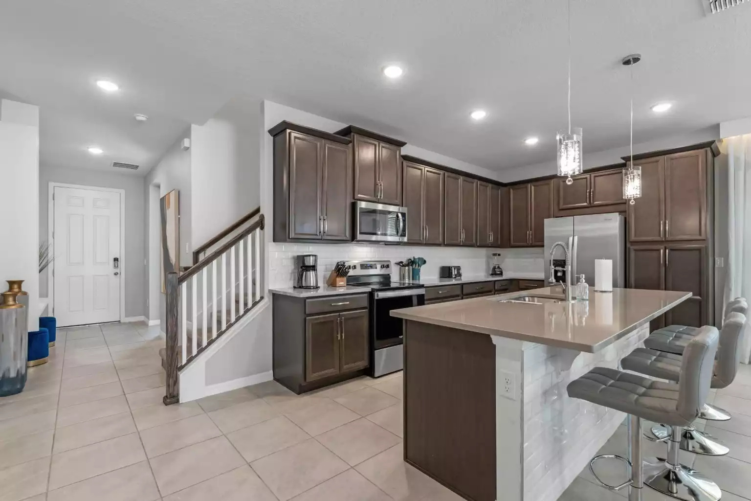 Modern full kitchen with microwave, dishwasher, coffee maker and refrigerator. Modern full kitchen with microwave, dishwasher, coffee maker and refrigerator. - Luxury Vacation Home Minutes From Disney World - Kissimmee